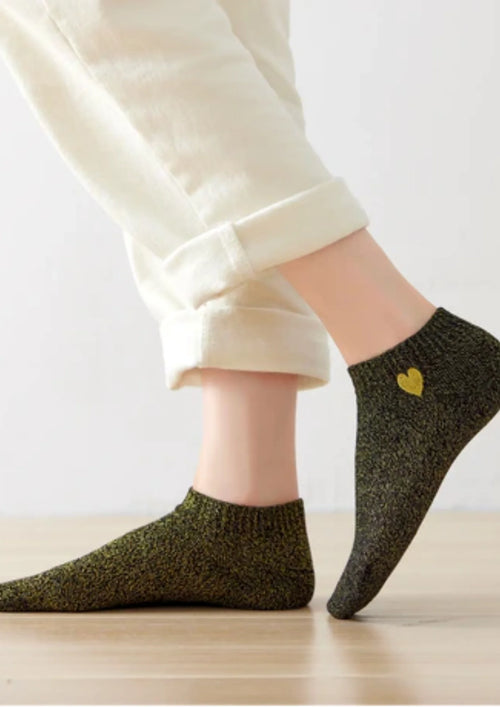 Chaussettes vertes scintillantes avec détail du cœur doré