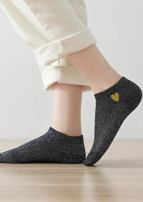 Chaussettes vertes scintillantes avec détail du cœur doré